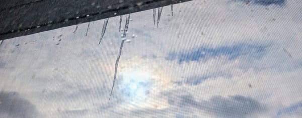 Icicles through an attic window at midday.  